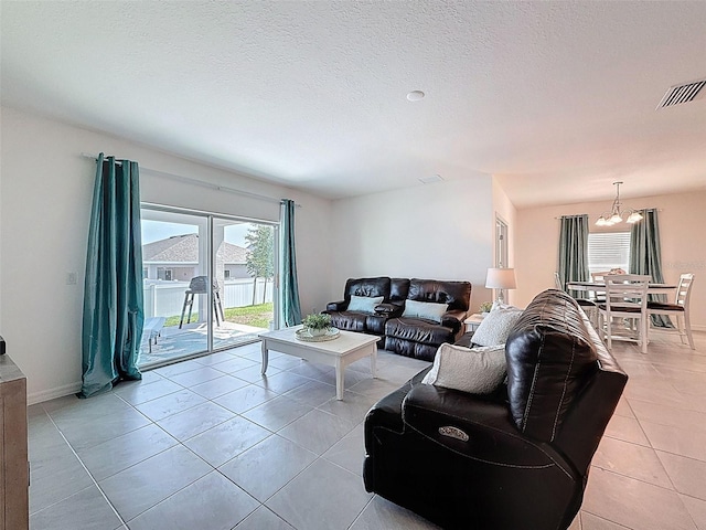 912 Scrub Oak Hammock Rd, Davenport, FL 33837 - living room with light tile patterned floors, a chandelier, and baseboards