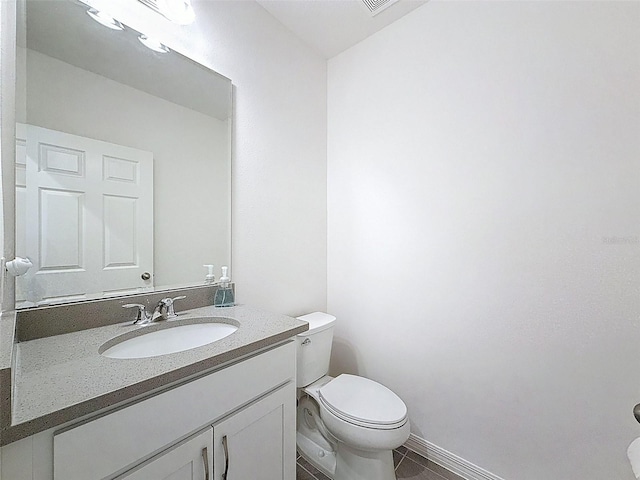 912 Scrub Oak Hammock Rd, Davenport, FL 33837 - bathroom featuring toilet, vanity, tile patterned flooring, and baseboards