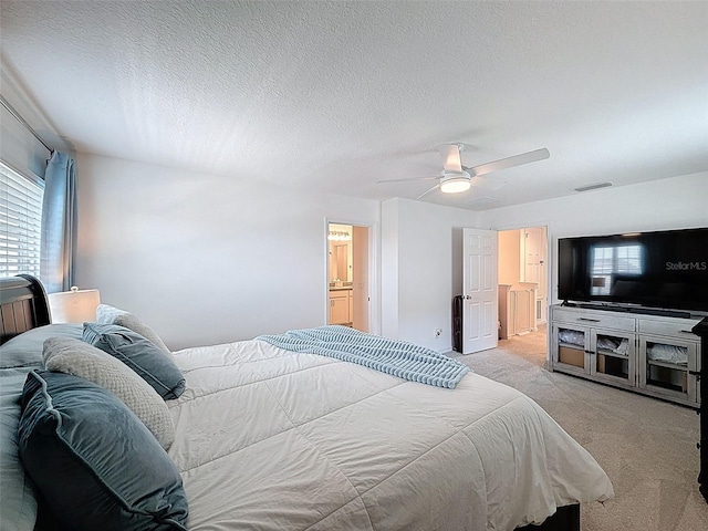 912 Scrub Oak Hammock Rd, Davenport, FL 33837 - bedroom featuring light carpet, a ceiling fan, ensuite bathroom, and a textured ceiling