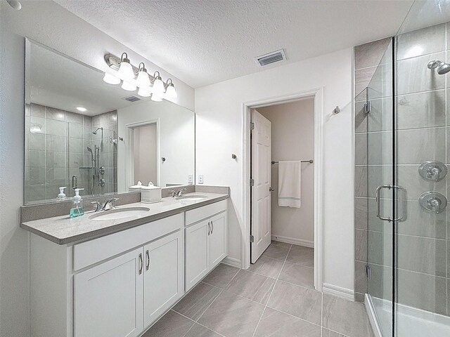 912 Scrub Oak Hammock Rd, Davenport, FL 33837 - bathroom featuring a stall shower, double vanity, baseboards, and a textured ceiling