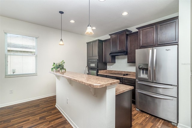 122 Port Royal Ct, Sebastian, FL 32958 - kitchen with black appliances, dark brown cabinets, light countertops, recessed lighting, and dark wood-style flooring