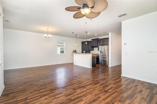 122 Port Royal Ct, Sebastian, FL 32958 - unfurnished living room with a ceiling fan, dark wood-style floors, a chandelier, baseboards, and recessed lighting