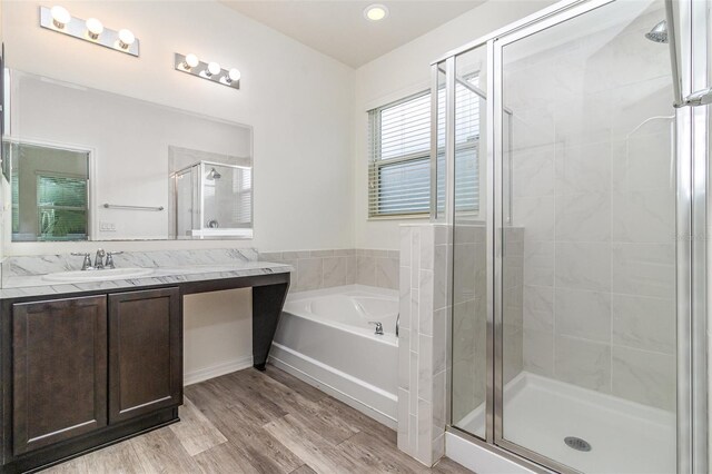 122 Port Royal Ct, Sebastian, FL 32958 - bathroom with a stall shower, a garden tub, wood finished floors, vanity, and recessed lighting