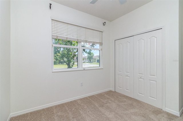 122 Port Royal Ct, Sebastian, FL 32958 - unfurnished bedroom with carpet flooring, baseboards, a closet, and a ceiling fan