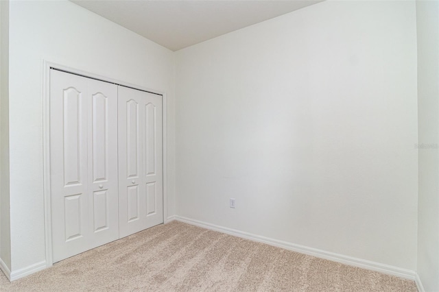 122 Port Royal Ct, Sebastian, FL 32958 - unfurnished bedroom featuring light carpet, a closet, and baseboards