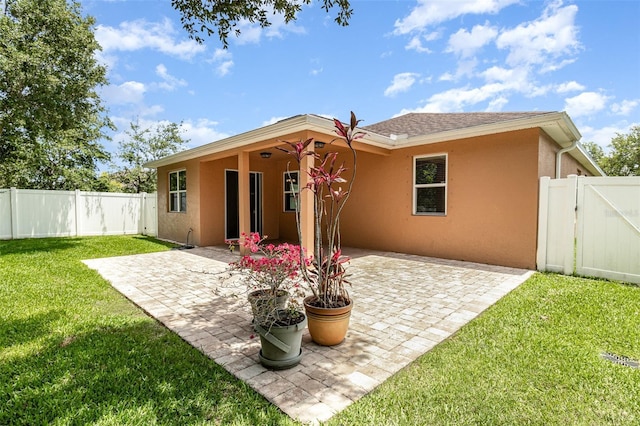 122 Port Royal Ct, Sebastian, FL 32958 - back of property featuring stucco siding, a gate, and a patio area