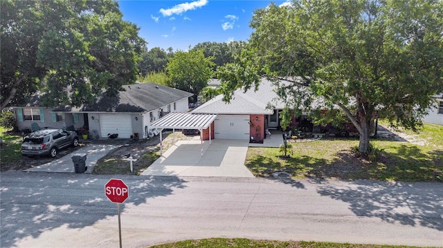 40 Westridge Rd, Davenport, FL 33837 - view of front of house featuring concrete driveway, a carport, and an attached garage