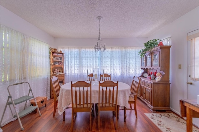 40 Westridge Rd, Davenport, FL 33837 - dining area with a chandelier, wood finished floors, and a textured ceiling