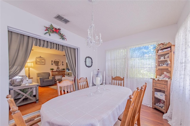 40 Westridge Rd, Davenport, FL 33837 - dining room with a chandelier, wood finished floors, and a textured ceiling
