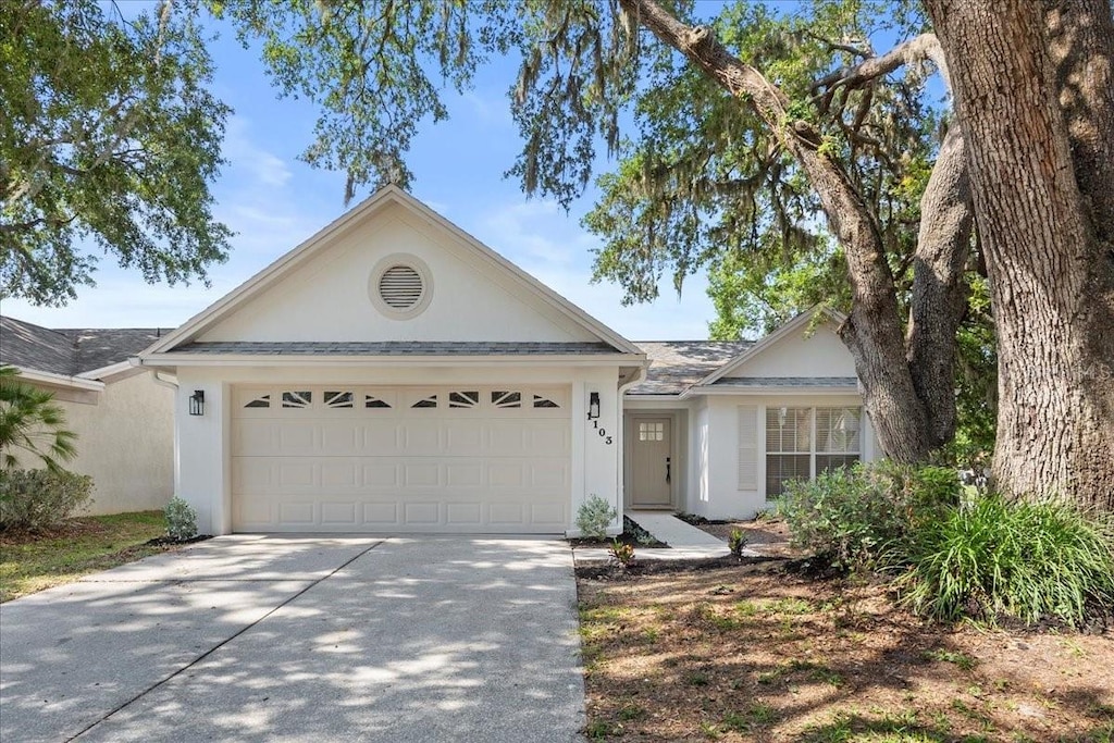 1103 Hardwood Dr, Valrico, FL 33596 - ranch-style house featuring stucco siding, concrete driveway, and a garage
