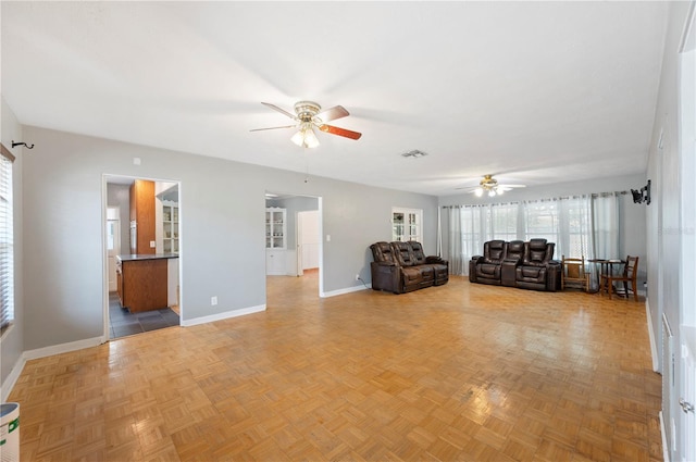 961 Oleander Dr SE, Winter Haven, FL 33880 - living area featuring ceiling fan and baseboards