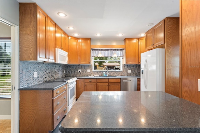 961 Oleander Dr SE, Winter Haven, FL 33880 - kitchen with white appliances, a sink, healthy amount of natural light, and backsplash