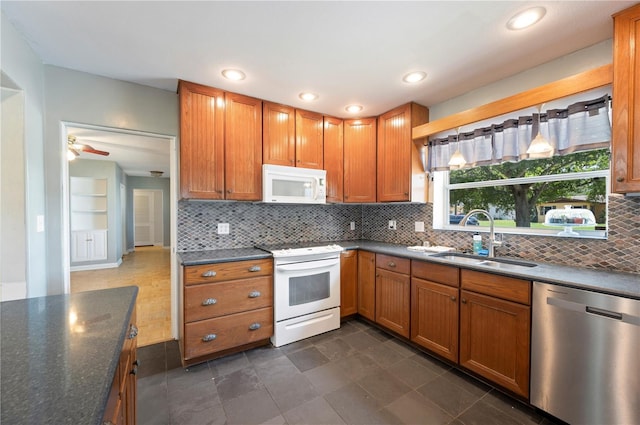 961 Oleander Dr SE, Winter Haven, FL 33880 - kitchen featuring white appliances, a sink, backsplash, brown cabinetry, and recessed lighting