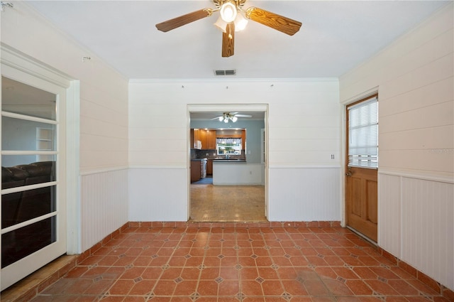 961 Oleander Dr SE, Winter Haven, FL 33880 - entryway with ceiling fan and wainscoting