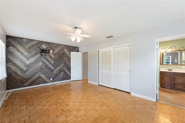 961 Oleander Dr SE, Winter Haven, FL 33880 - unfurnished bedroom featuring a closet, baseboards, a ceiling fan, and connected bathroom