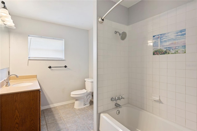 961 Oleander Dr SE, Winter Haven, FL 33880 - bathroom with toilet, bathtub / shower combination, tile patterned floors, vanity, and baseboards