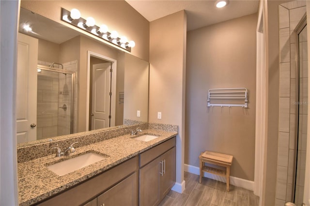 1100 Sugarwood St, Davenport, FL 33837 - bathroom with a stall shower, double vanity, baseboards, recessed lighting, and wood finished floors
