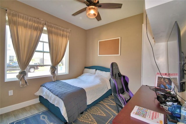 1100 Sugarwood St, Davenport, FL 33837 - bedroom with wood finished floors, a ceiling fan, and baseboards