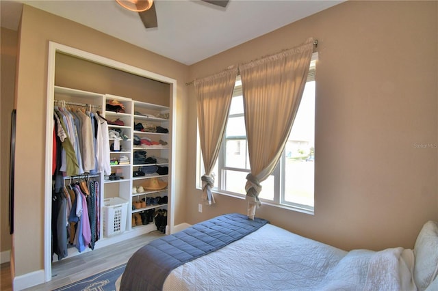 1100 Sugarwood St, Davenport, FL 33837 - bedroom featuring a closet, baseboards, and wood finished floors