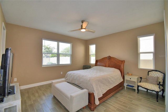 1100 Sugarwood St, Davenport, FL 33837 - bedroom with light wood finished floors, baseboards, and a ceiling fan