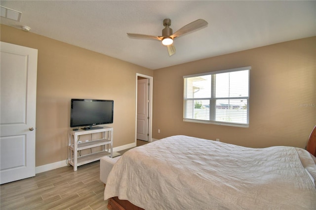 1100 Sugarwood St, Davenport, FL 33837 - bedroom featuring baseboards, wood finished floors, and a ceiling fan