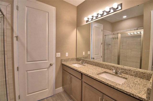1100 Sugarwood St, Davenport, FL 33837 - bathroom with double vanity, a shower stall, baseboards, and recessed lighting
