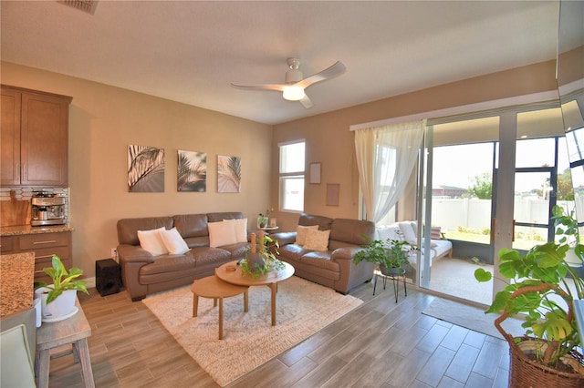 1100 Sugarwood St, Davenport, FL 33837 - living room with light wood-type flooring and a ceiling fan