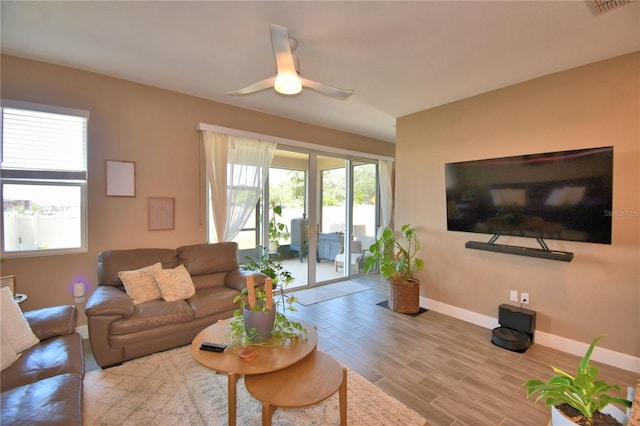 1100 Sugarwood St, Davenport, FL 33837 - living area with baseboards, wood finished floors, and ceiling fan