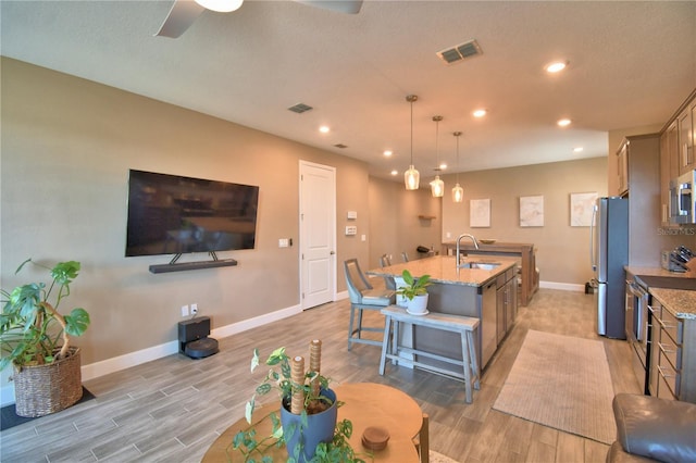 1100 Sugarwood St, Davenport, FL 33837 - living area featuring baseboards, light wood-style flooring, recessed lighting, and a ceiling fan