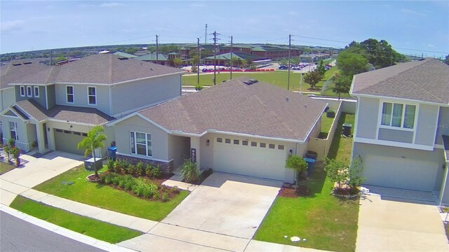 1100 Sugarwood St, Davenport, FL 33837 - view of front of home with driveway, stucco siding, a front yard, and a residential view