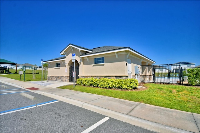 1100 Sugarwood St, Davenport, FL 33837 - view of front of home with uncovered parking, stucco siding, and stone siding