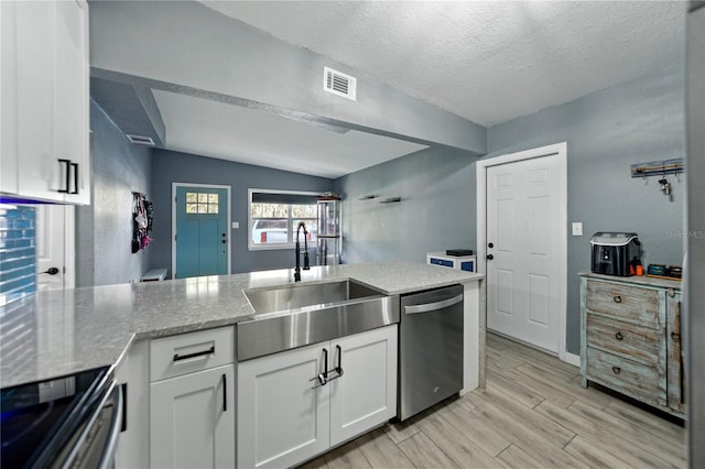 1140 W Seminole Trl, Bartow, FL 33830 - kitchen featuring stainless steel appliances, a sink, white cabinets, light stone counters, and light wood finished floors