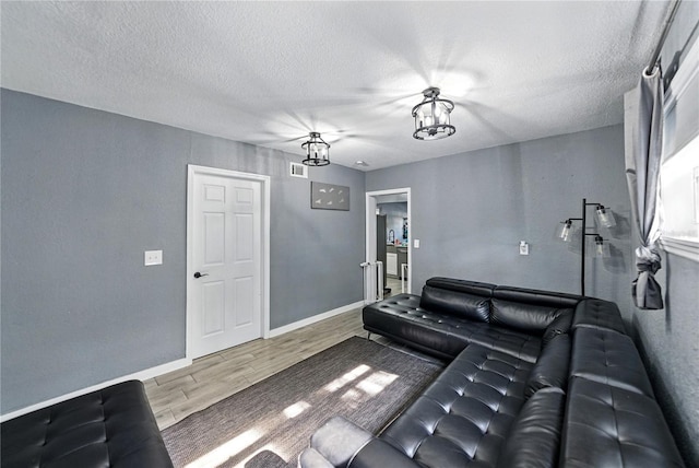 1140 W Seminole Trl, Bartow, FL 33830 - living room with wood finished floors, a textured ceiling, and baseboards