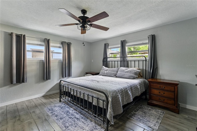 1140 W Seminole Trl, Bartow, FL 33830 - bedroom featuring wood finished floors, baseboards, a textured ceiling, and a ceiling fan