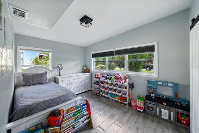1140 W Seminole Trl, Bartow, FL 33830 - bedroom featuring multiple windows, vaulted ceiling, and wood finished floors