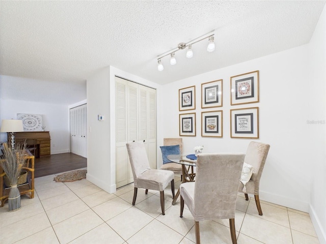 2700 Bayshore Blvd Unit 3210, Dunedin, FL 34698 - dining area with light tile patterned floors, baseboards, and a textured ceiling