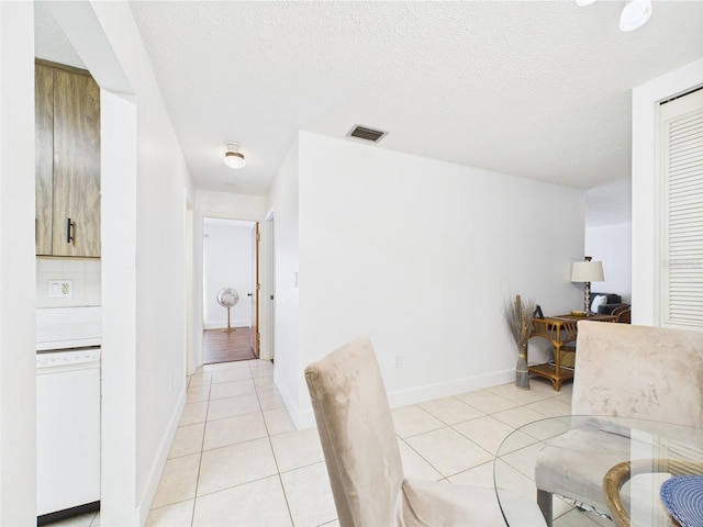 2700 Bayshore Blvd Unit 3210, Dunedin, FL 34698 - dining area featuring light tile patterned floors, baseboards, and a textured ceiling