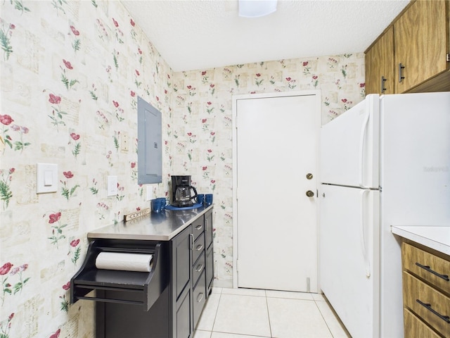 2700 Bayshore Blvd Unit 3210, Dunedin, FL 34698 - kitchen with wallpapered walls, freestanding refrigerator, electric panel, light countertops, and brown cabinets