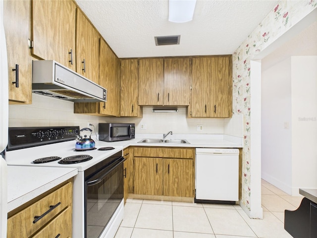 2700 Bayshore Blvd Unit 3210, Dunedin, FL 34698 - kitchen with electric range, dishwasher, exhaust hood, a sink, and light countertops