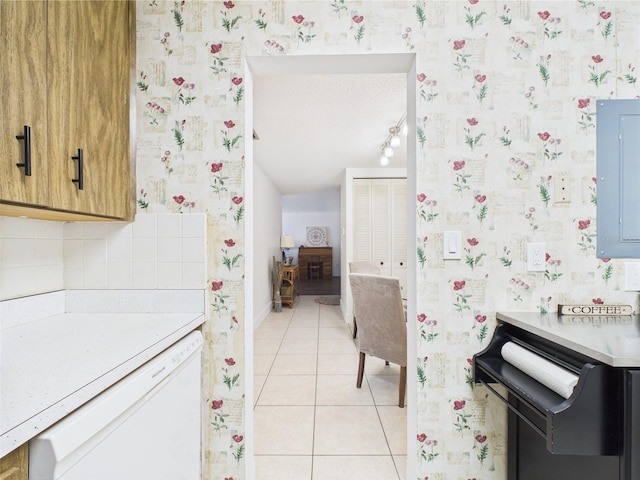 2700 Bayshore Blvd Unit 3210, Dunedin, FL 34698 - kitchen featuring dishwasher, wallpapered walls, light tile patterned floors, light countertops, and baseboards