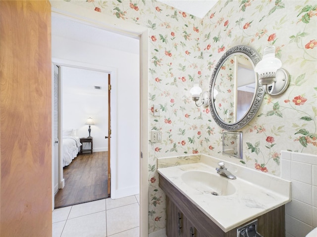 2700 Bayshore Blvd Unit 3210, Dunedin, FL 34698 - bathroom featuring wallpapered walls, vanity, and tile patterned floors