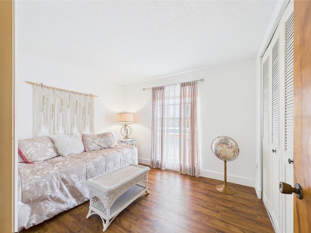 2700 Bayshore Blvd Unit 3210, Dunedin, FL 34698 - bedroom featuring wood finished floors, a closet, baseboards, and a textured ceiling