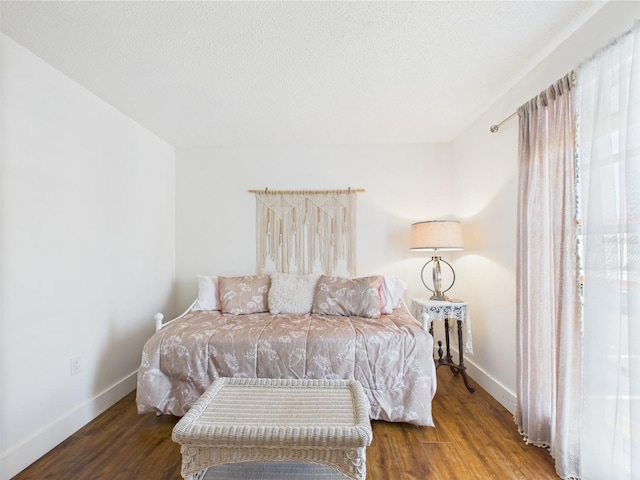 2700 Bayshore Blvd Unit 3210, Dunedin, FL 34698 - bedroom featuring wood finished floors, baseboards, and a textured ceiling