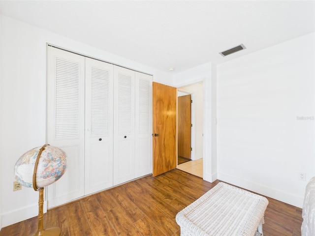 2700 Bayshore Blvd Unit 3210, Dunedin, FL 34698 - bedroom featuring a closet, wood finished floors, and baseboards