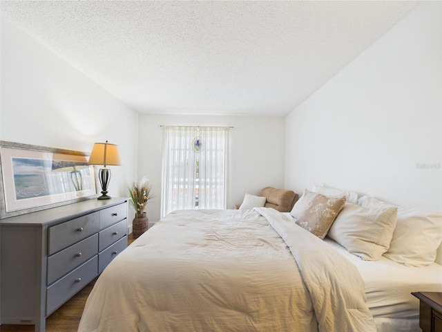 2700 Bayshore Blvd Unit 3210, Dunedin, FL 34698 - bedroom with dark wood-style floors, a textured ceiling, and access to outside