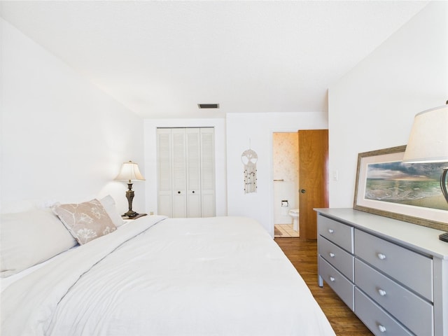 2700 Bayshore Blvd Unit 3210, Dunedin, FL 34698 - bedroom with dark wood finished floors, a closet, and connected bathroom