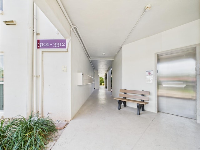 2700 Bayshore Blvd Unit 3210, Dunedin, FL 34698 - corridor featuring elevator and concrete floors