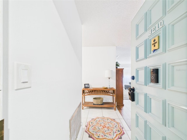 2700 Bayshore Blvd Unit 3210, Dunedin, FL 34698 - hall featuring light tile patterned floors and a textured ceiling