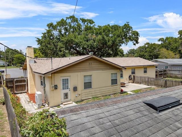 320 Boger Blvd S, Lakeland, FL 33803 - back of property with a patio, a chimney, a shingled roof, and a cooling unit