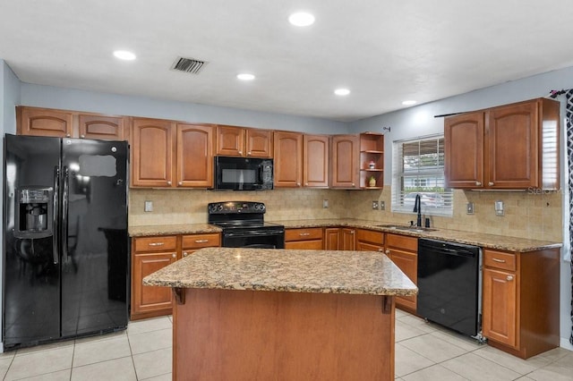320 Boger Blvd S, Lakeland, FL 33803 - kitchen with black appliances, a sink, light stone countertops, light tile patterned floors, and recessed lighting